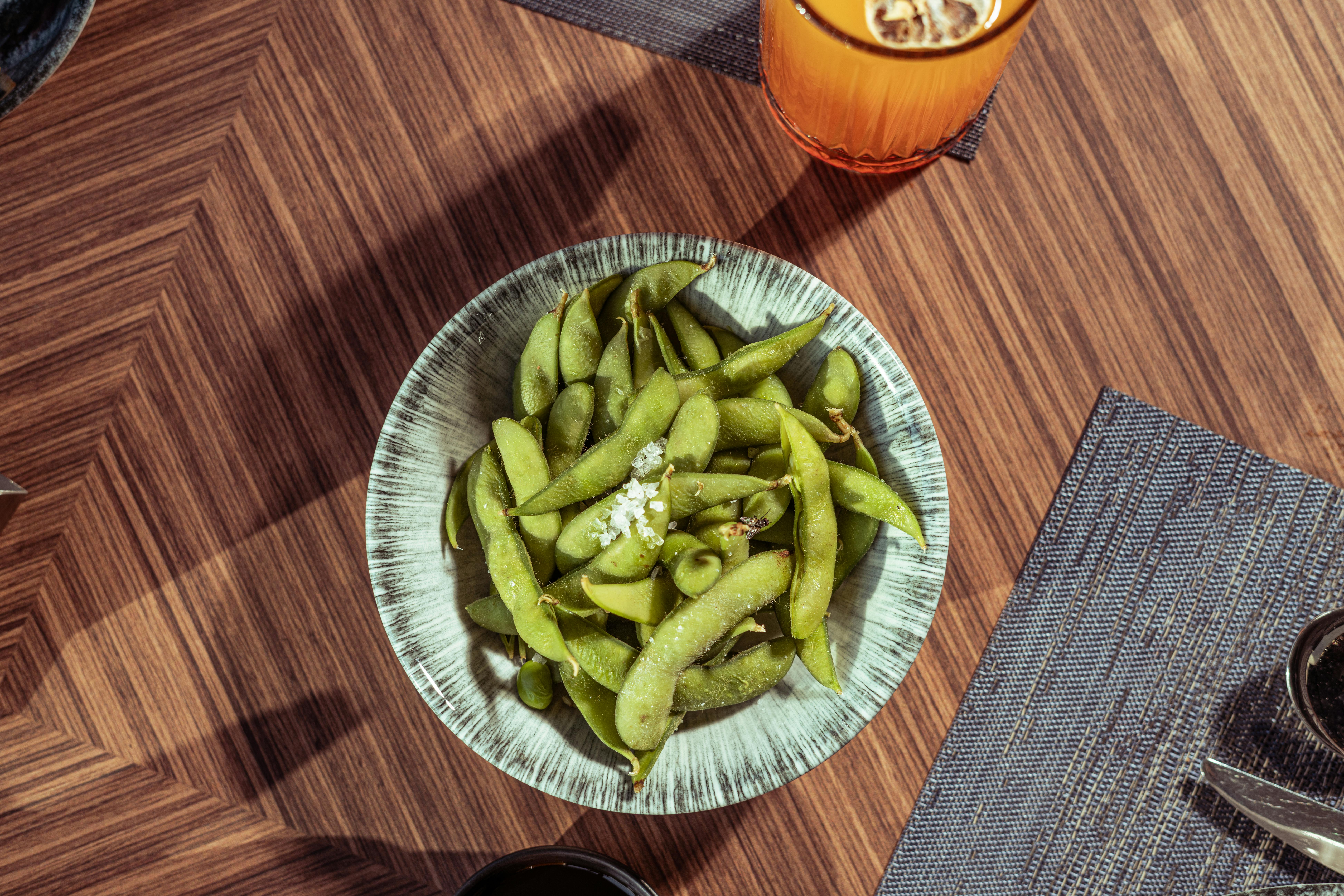 Bowl of edamame on a wooden table